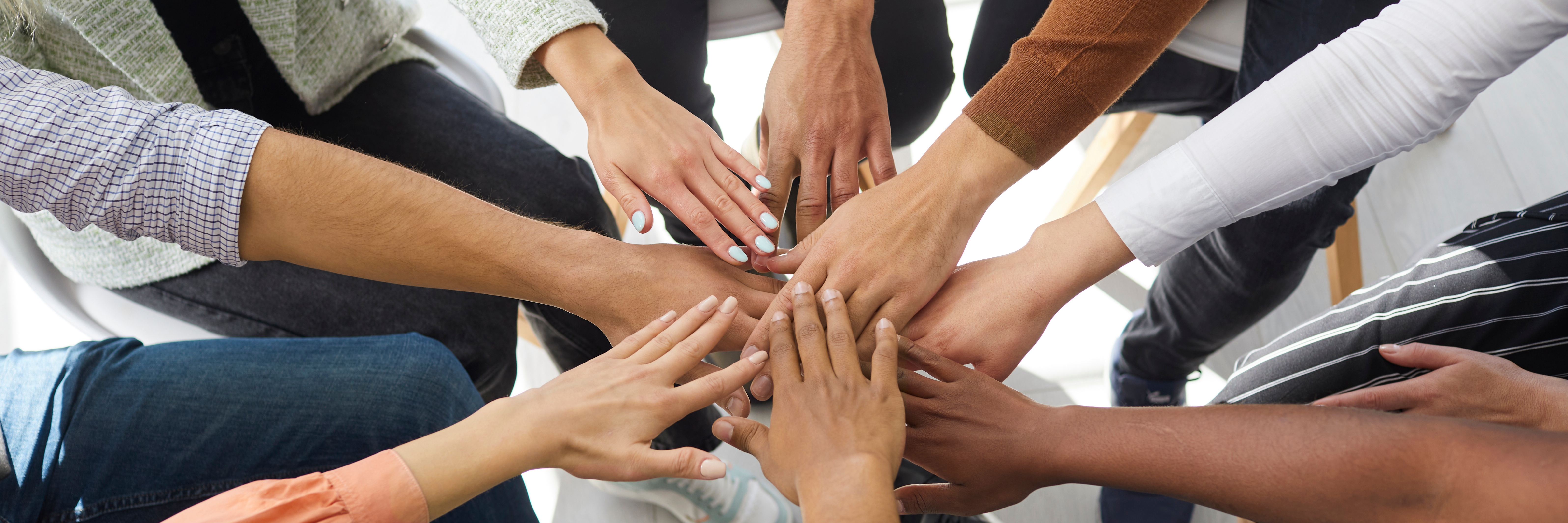 Closeup banner of diverse people stack hands