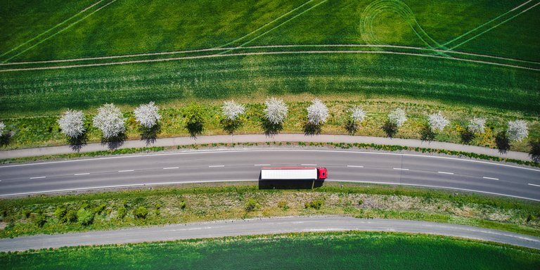 Perspectives Drone shot directly above a truck moving on a road