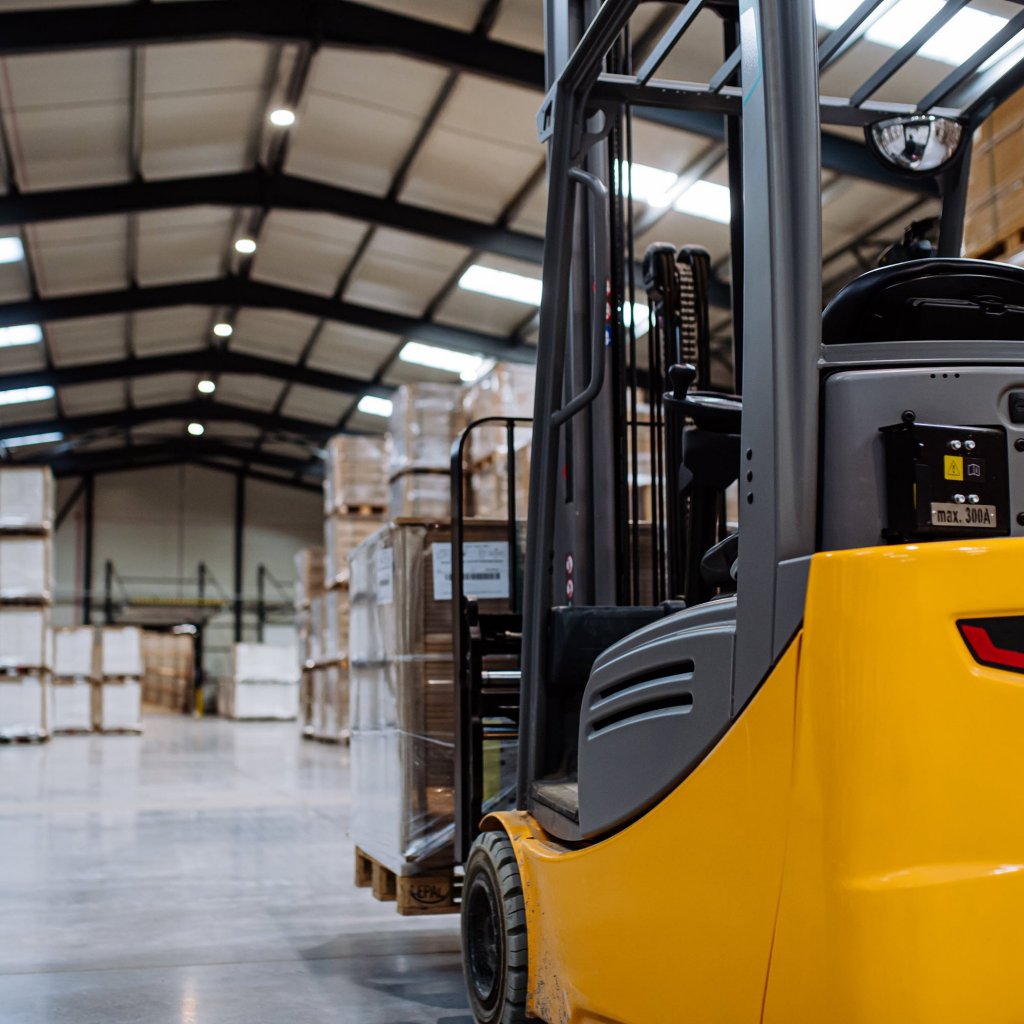 Fork-lift truck in a warehouse