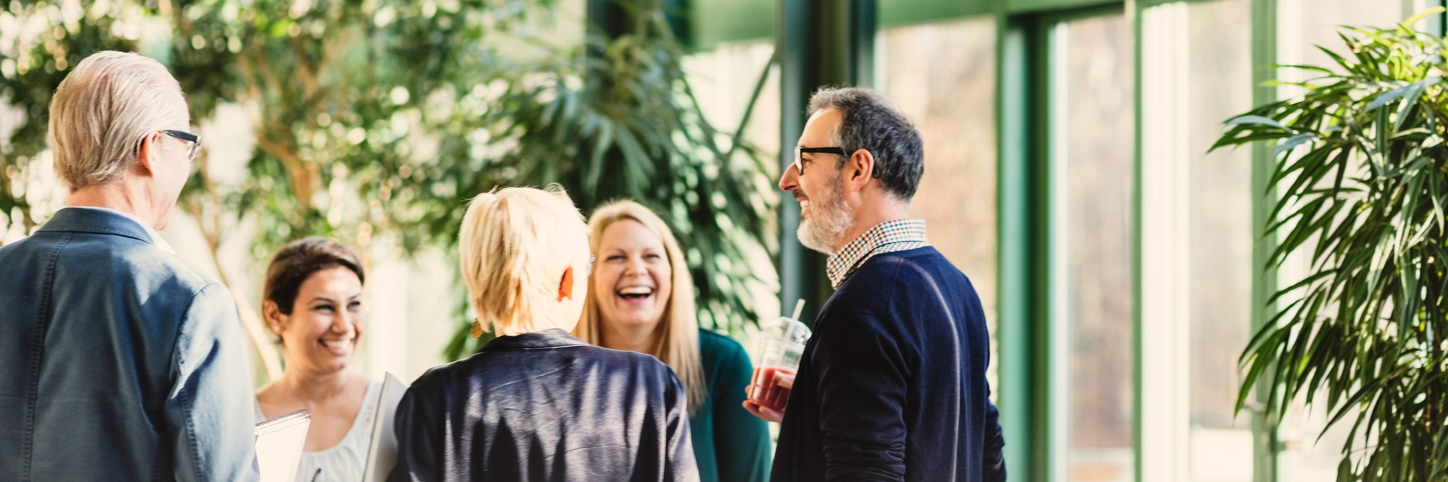 Group of professionals laughing at networking event