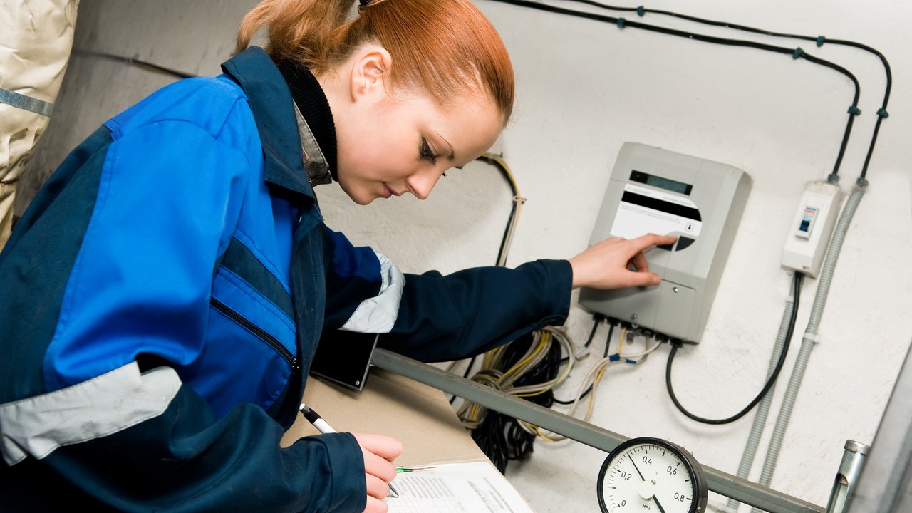 ASME Non-Nuclear Inspection Services woman engineer checking technical data of heating system equipment in a boiler room
